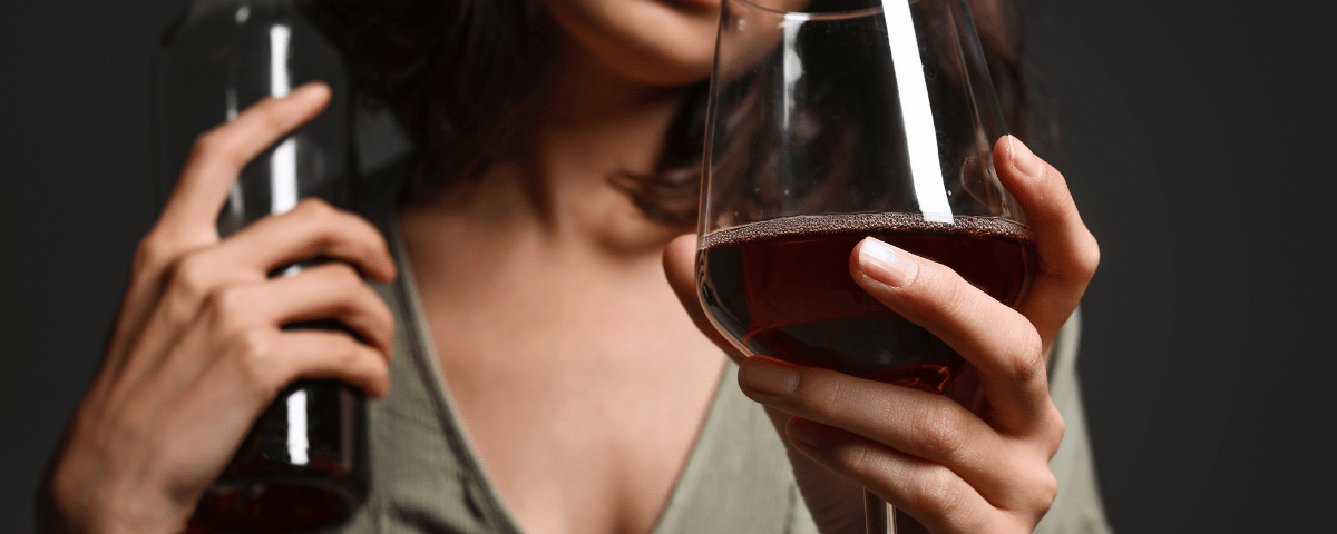 Mujer con una botella y una copa de vino